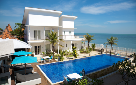 Front view of stunning beachfront villas in Phuket, representing high-end property investments for international buyers.