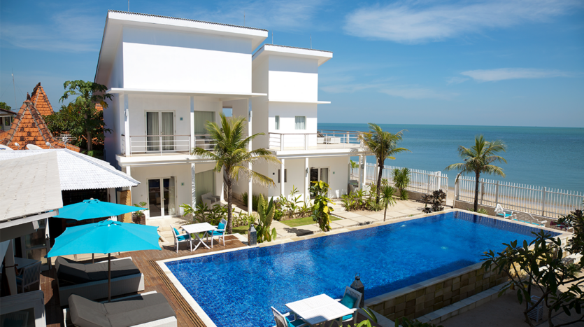 Front view of stunning beachfront villas in Phuket, representing high-end property investments for international buyers.