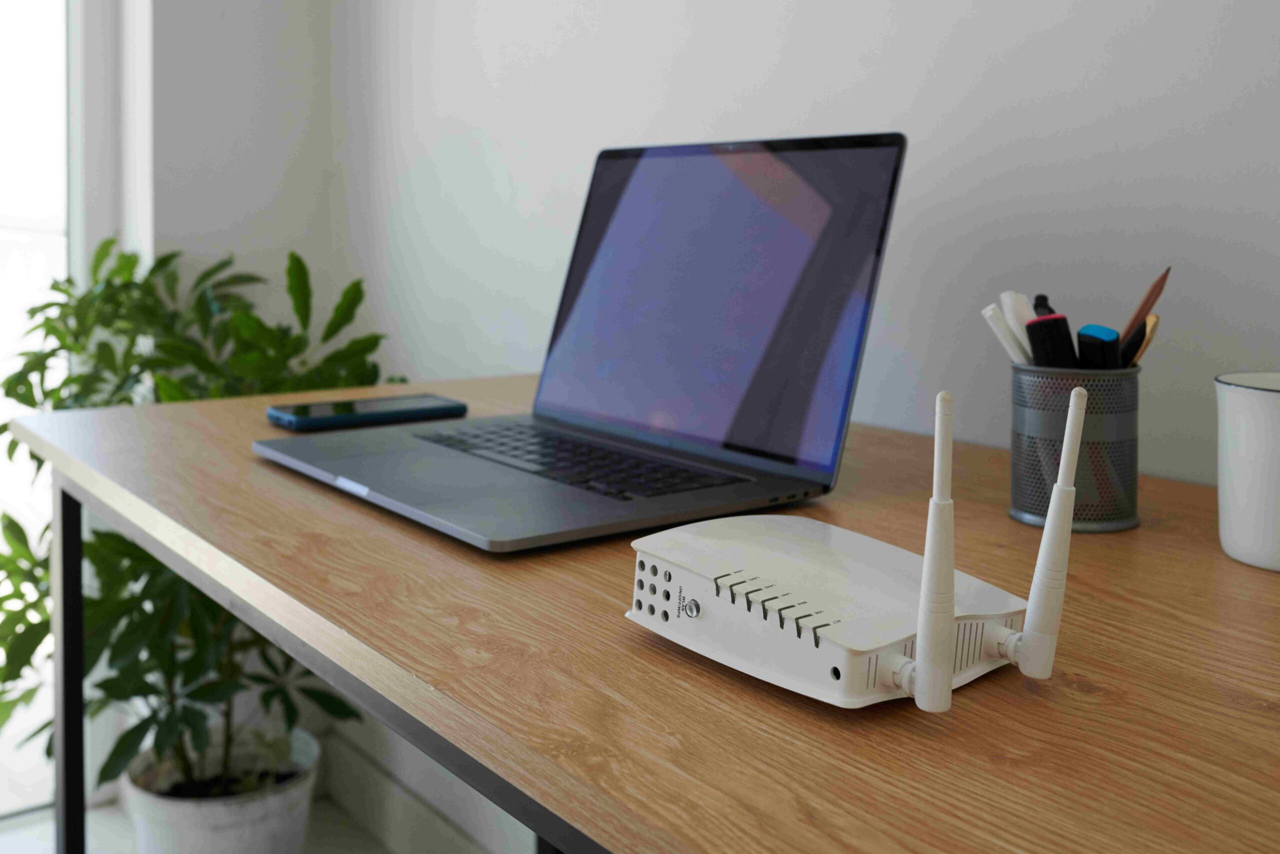 wifi-router-next-to-laptop-2025-01-29-12-49-06-utc_11zon