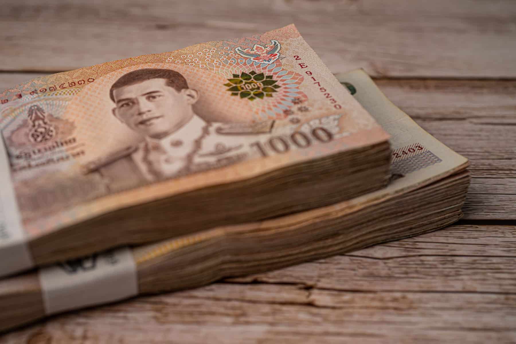 stack-of-thai-baht-banknotes-on-wooden-background-2025-02-24-16-07-57-utc-(1)