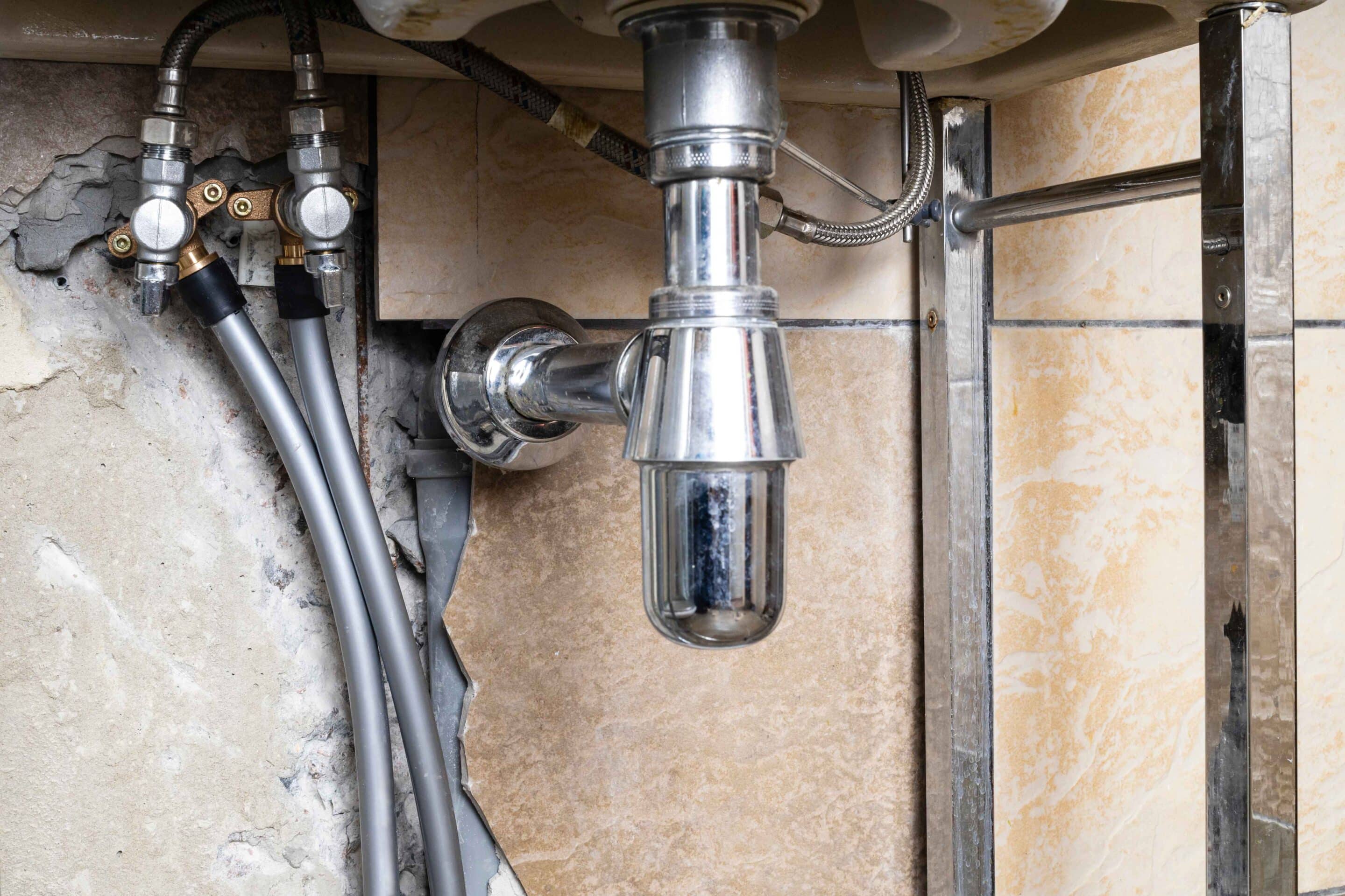 water-pipes-connected-to-valve-of-sink-in-bathroom-2024-10-18-05-22-29-utc_11zon